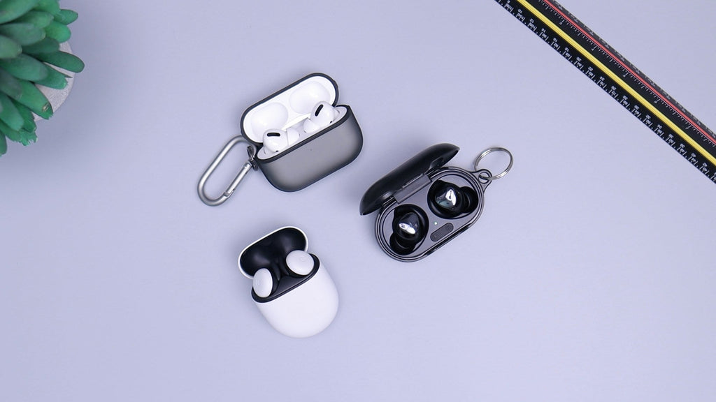 three sets of wireless earphones displayed on a table