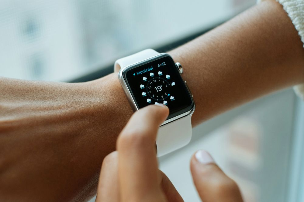 apple watch shown on wrist with white strap
