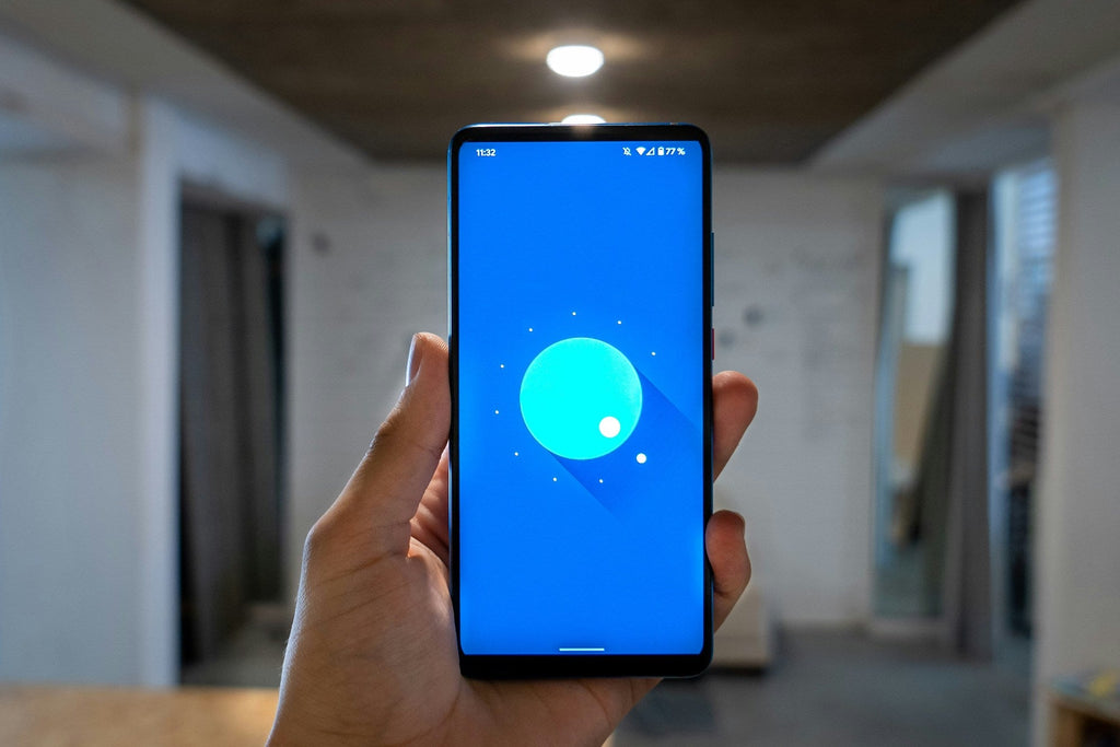android phone being held in the air showing a blue screen